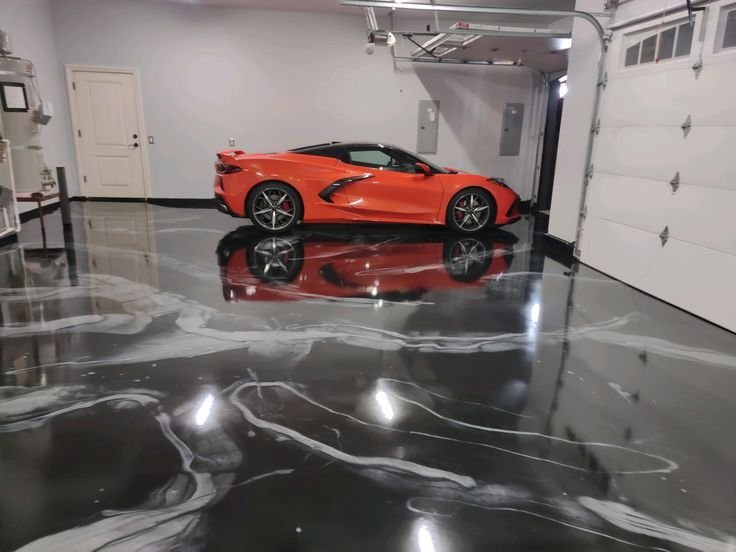 High-gloss resin rich floor with black and white metallic garage epoxy flooring and a smooth reflective finish.