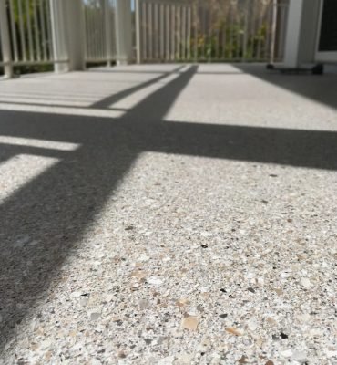 Expertly polished concrete surface featuring a high-quality resin rich floors finish with a smooth and durable appearance.