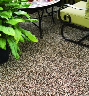 Graveled epoxy flooring with a textured resin rich floors finish in a clean and spacious interior setting.