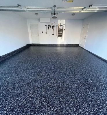 Premium epoxy flake flooring with a smooth resin rich floors finish in a clean residential garage.