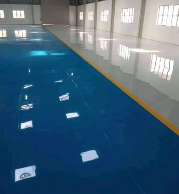 High-gloss blue resin rich floor with durable industrial epoxy flooring in a clean and organized industrial facility.