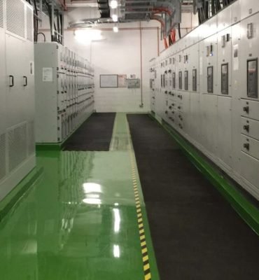 High-gloss green resin rich floors with durable industrial epoxy flooring in a clean and organized industrial facility.