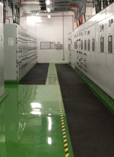 High-gloss green resin rich floors with durable industrial epoxy flooring in a clean and organized industrial facility.